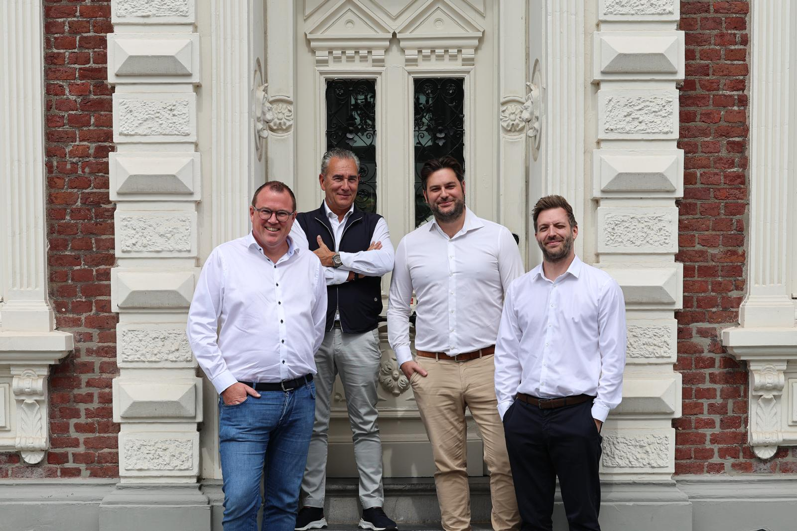 The D&T Capital team standing together outside a historic building